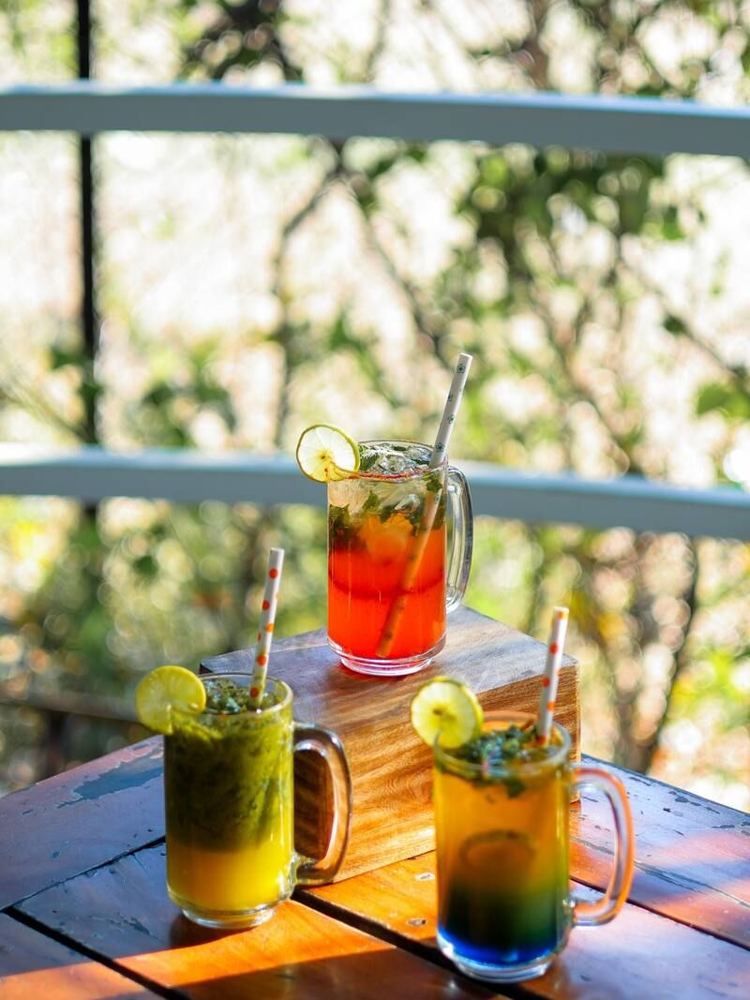 Three mocktails on a wooden table