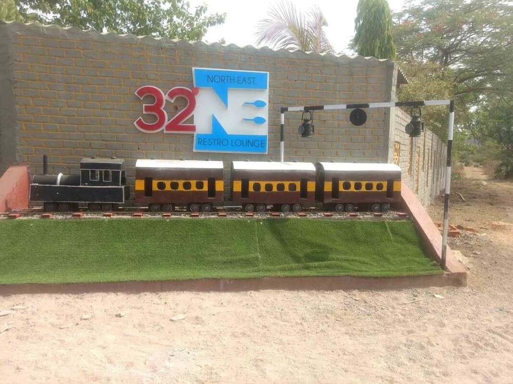 Toy train on the lawn in front of the 32 NE wall
